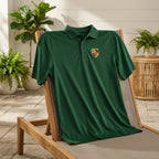 Stylish low-angle shot of men's Porsche polyester polo draped over outdoor lounge chair, highlighting fabric softness and fit.