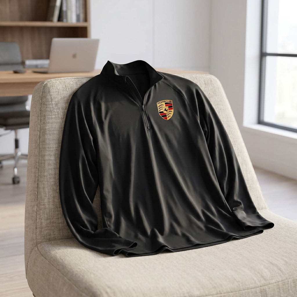 Casually draped black men's athletic shirt on lounge chair in bright home office setting.