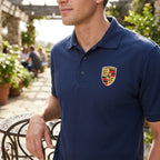 Close-up of Mens Porsche Car Dry Blend Polo fabric highlighting moisture-wicking knit texture in natural outdoor light.