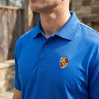 Close-up of men's Porsche polyester polo fabric showing textured, moisture-wicking material with reinforced stitching and tagless collar.