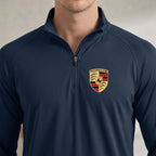 Close-up of Porsche men's quarter-zip shirt showcasing fabric texture, zipper detail, and stitching in a well-lit indoor studio.