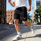 Male model running in Chevrolet Corvette athletic fleece shorts along city sidewalk, showcasing movement, fit, and performance in an urban scene.