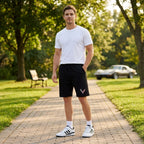 Men wearing Chevrolet Corvette athletic fleece shorts in an outdoor park setting, demonstrating comfort, fit, and flexibility during a casual walk.