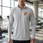 Close-up of men's Porsche lightweight athletic shirt displaying breathable polyester fabric and athletic fit on a model in a gym.
