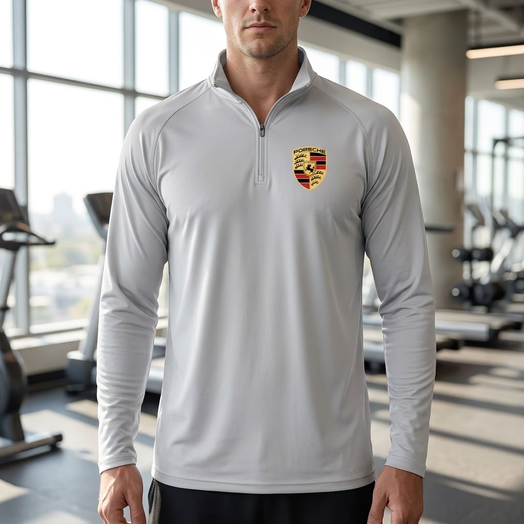 Close-up of men's Porsche lightweight athletic shirt displaying breathable polyester fabric and athletic fit on a model in a gym.