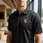 Close-up of men's Porsche polyester polo highlighting collar, upper chest, and fabric texture in natural daylight.