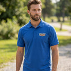 Close-up of men's Cadillac Car Dry Blend Polo shirt showing collar placket and fabric texture on a male model outdoors.