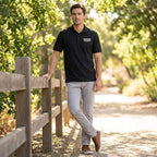 Full-body shot of a male model wearing Men’s Cadillac Car Dry Blend Polo in outdoor setting showcasing fit and relaxed style.