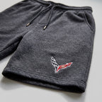 Close-up of men's Chevrolet Corvette athletic fleece shorts shows textured fabric, stitching, soft stretch, and durability.