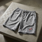 Men's Corvette athletic shorts laid flat against concrete background, highlighting premium fabric blend and subtle stretch.