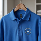 Close-up of Mens Mercedes-Benz Dry Blend Polo displaying textured cotton-polyester knit fabric, collar, cuffs, and dyed-to-match buttons.