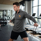 Male athlete wearing Porsche athletic shirt during gym warm-up, demonstrating fit and flexibility in workout environment.