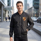 Full-body view of male model wearing Porsche bomber jacket in urban setting highlighting casual style and breathability.