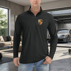 Close-up of men's Porsche lightweight quarter-zip athletic shirt on a sleek hanger, highlighting the moisture-wicking fabric and stitching.