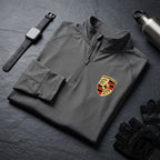 Flat lay of Porsche men's athletic shirt on dark textured surface with fitness accessories, emphasizing fabric details.