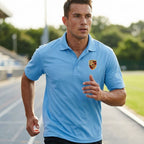Sporty male athlete running in bright daylight wearing navy Porsche polyester polo, emphasizing breathability and performance features.
