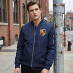 Male model in Porsche bomber jacket in urban setting during overcast weather, focusing on subtle textures, zipper, and casual style.