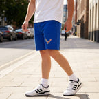 Full-body shot of man outdoors wearing Chevrolet Corvette shorts on a sunny day, demonstrating mobility and athletic design.