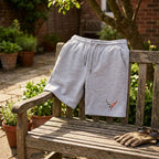 Casual scene with men's Chevrolet Corvette athletic fleece shorts draped over a rustic outdoor bench, highlighting soft fabric and lifestyle versatility.