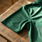 Detailed view of polo sleeve and side seam on men's Porsche polyester polo, displaying reinforced stitching and fabric quality.