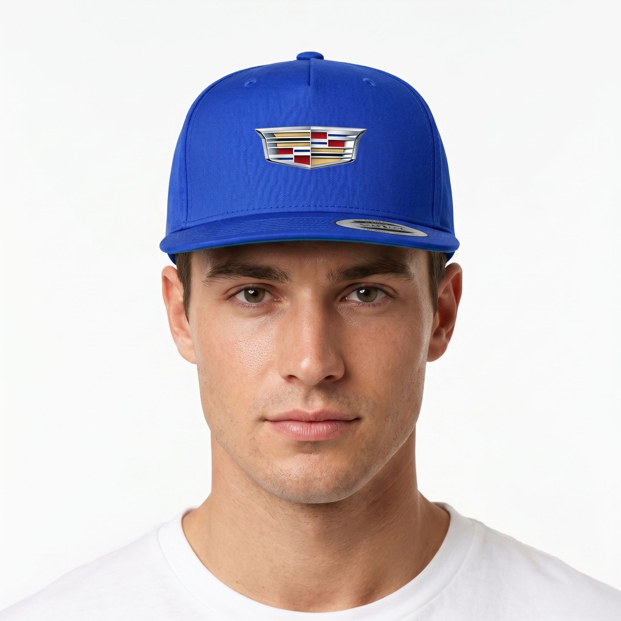 Studio shot of male model wearing royal blue Cadillac snapback hat with detailed embroidery on a white background.