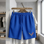 Men's fleece shorts hanging on a rustic wooden hanger, emphasizing fit, fabric quality, and craftsmanship in a retail setting.
