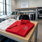 Polo shirt hanging on retail rack showing precise stitching and OEKO-TEX certification label.