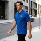 Side angle of men's Porsche Car Dry Blend Polo on male model walking outdoors, focusing on fabric texture and design details.